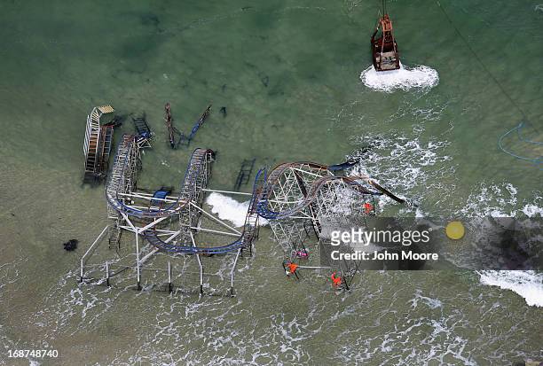 Crane demolishes the JetStar roller coaster more than 6 months after it fell into the ocean during Superstorm Sandy on May 14, 2013 in Seaside...