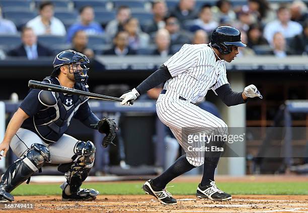 Curtis Granderson of the New York Yankees hits into a double play to end the first inning as Kelly Shoppach of the Seattle Mariners catches on May...