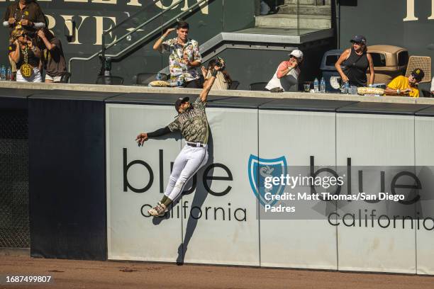 Fernando Tatis Jr. #23 of the San Diego Padres makes a jumping catch in the sixth inning to rob a home run against the St. Louis Cardinals on...