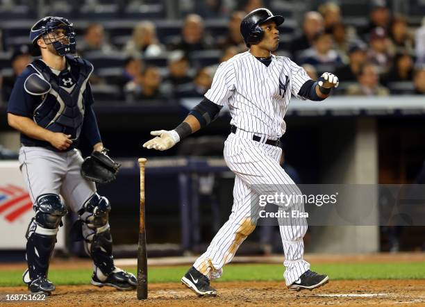 Robinson Cano of the New York Yankees watches his two RBI double in the seventh inning as Kelly Shoppach of the Seattle Mariners watches on May 14,...