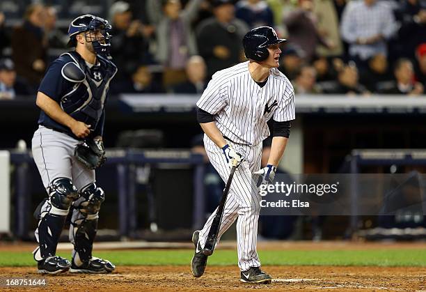 Lyle Overbay of the New York Yankees hits an RBI sac fly in the seventh inning as Kelly Shoppach of the Seattle Mariners defends on May 14, 2013 at...