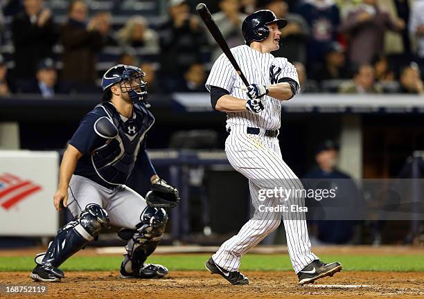 Lyle Overbay of the New York Yankees watches his SAC fly to score the game winning run as Kelly Shoppach of the Seattle Mariners defends on May 14,...