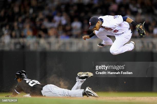 Dewayne Wise of the Chicago White Sox is safe at second base as Pedro Florimon of the Minnesota Twins jumps out of the way during the eighth inning...