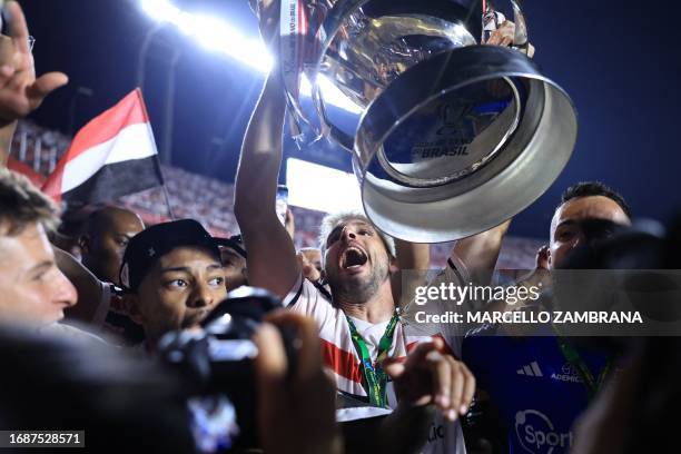 Sao Paulo's forward Jonathan Calleri holds the trophy at the end of the Copa do Brasil final second leg football match between Flamengo and Sao Paulo...