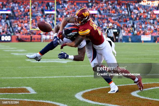 Benjamin St-Juste of the Washington Commanders breaks a up potential game tying two point conversion intended for Courtland Sutton of the Denver...