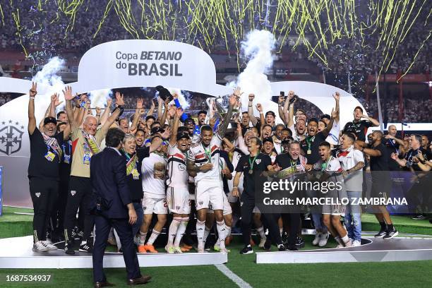 Sao Paulo football team celebrates with the trophy at the end of the Copa do Brasil final second leg football match between Flamengo and Sao Paulo at...