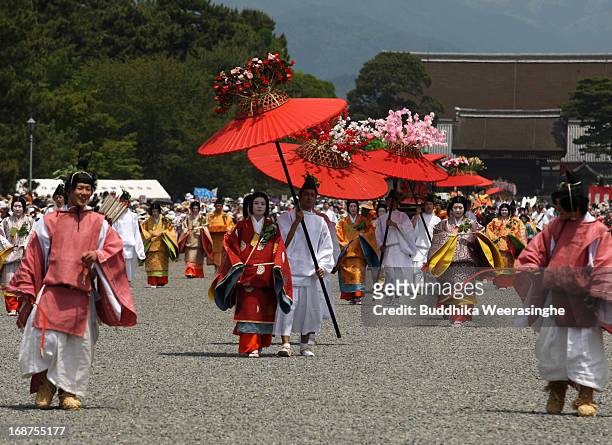 People dressed in traditional costumes walk in the procession of the Aoi Festival at the Imperial Palace on May 15, 2013 in Kyoto, Japan. Aoi...