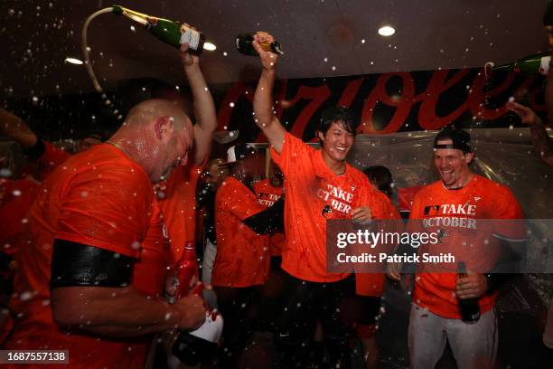 Shintaro Fujinami of the Baltimore Orioles celebrates in the clubhouse after the Baltimore Orioles clinched a 2023 MLB playoff berth after defeating...