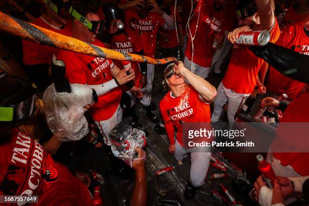 Heston Kjerstad of the Baltimore Orioles drinks from the 'Homer Hose' as he and teammates celebrate in the clubhouse after the Baltimore Orioles...