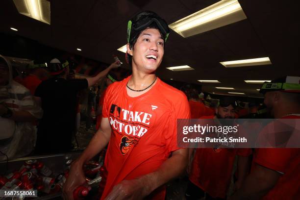 Shintaro Fujinami of the Baltimore Orioles celebrates in the clubhouse after the Baltimore Orioles clinched a 2023 MLB playoff berth after defeating...