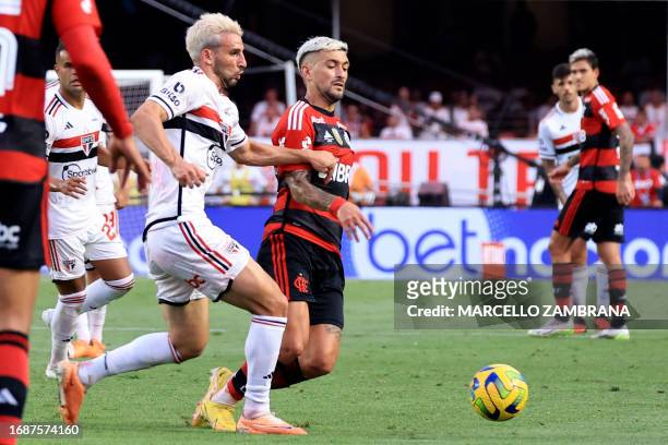 Sao Paulo's forward Jonathan Calleri and Flamengo's Uruguayan midfielder Giorgian de Arrascaeta fight for the ball during the Copa do Brasil final...