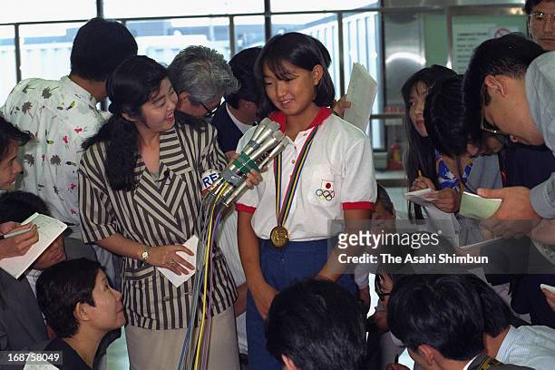 Barcelona Olympic Women's 200m Breaststroke Gold Medalist Kyoko Iwasaki is surrounded by media reporters upon arrival at New Tokyo International...