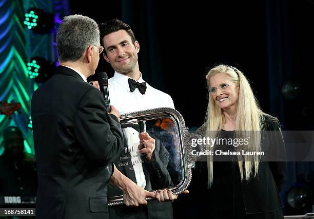 President & CEO Del Bryant and BMI Vice President & General Manager, Writer/Publisher Relations Barbara Cane present singer/songwriter Adam Levine...