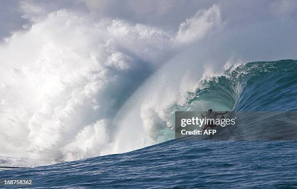 Surfer falls in a wipeout at Teahupoo in Tahiti on May 14, 2013. Top surfers in the world gathered in Teahupoo since the beginning of the week to...