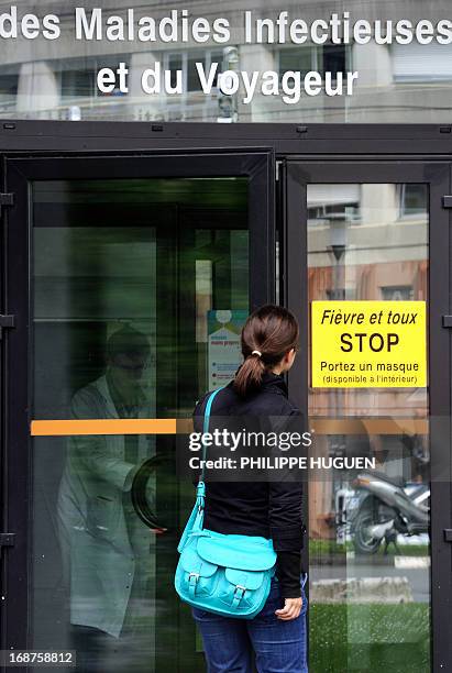 Woman enters, on May 14, 2013 the universitary and regional service of the infectious and travel diseases unit at the Tourcoing Hospital, northern...