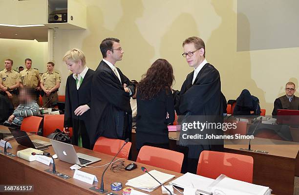 Lawyers Anja Sturm , Wolfgang Stahl and Wolfgang Heer chat with their client Beate Zschaepe in the courtroom on day three of the NSU neo-Nazis murder...