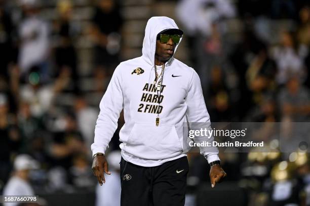 Head coach Deion Sanders of the Colorado Buffaloes walks on the field as players warm up before a game against the Colorado State Rams at Folsom...