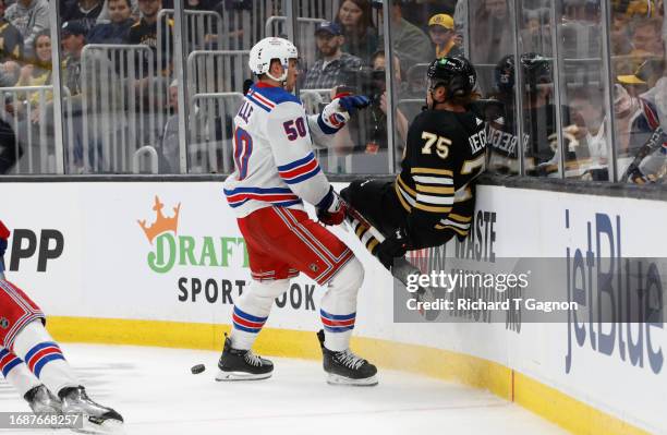 Will Cuylle of the New York Rangers checks Alec Regula of the Boston Bruins during the second period in a preseason game at the TD Garden on...