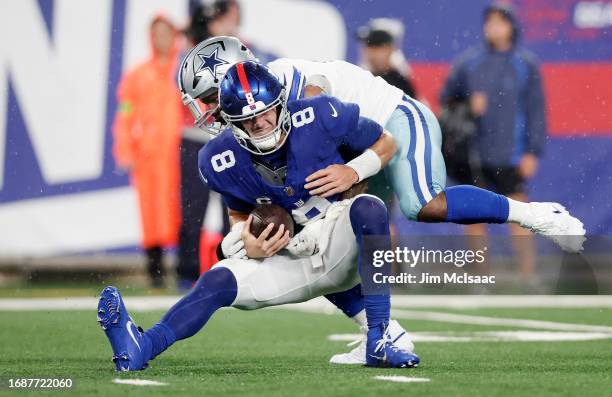 Daniel Jones of the New York Giants is sacked in the first half by Micah Parsons of the Dallas Cowboys at MetLife Stadium on September 10, 2023 in...