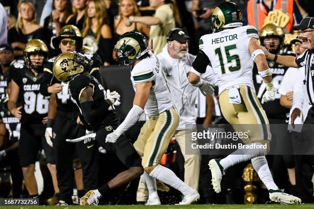 Wide receiver Travis Hunter of the Colorado Buffaloes is hit near the sideline on a pass attempt by defensive back Henry Blackburn of the Colorado...