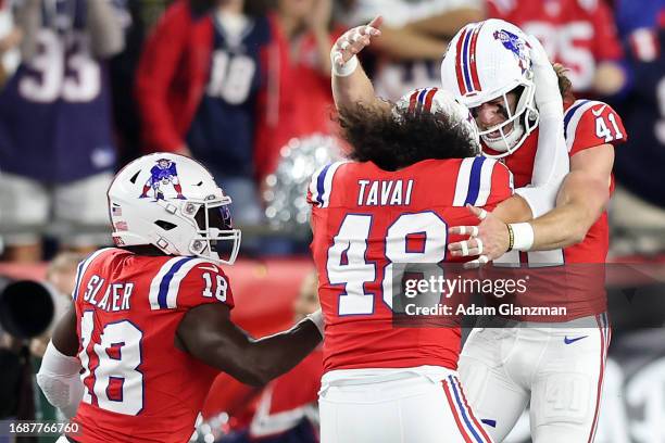 Brenden Schooler of the New England Patriots celebrates with teammates after blocking a field goal attempt during the third quarter against the Miami...