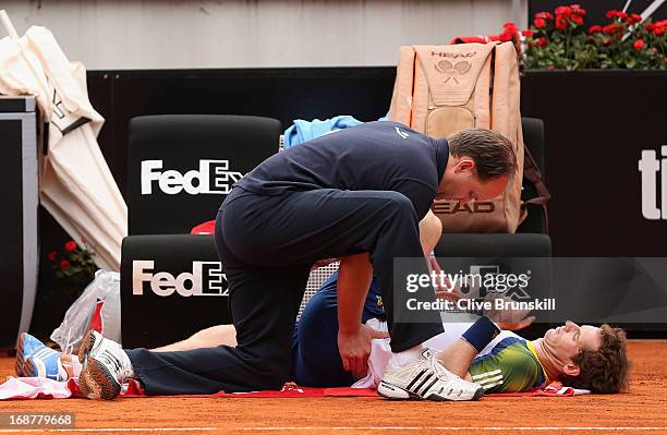 Andy Murray of Great Britain receives an injury time ut against Marcel Granollers of Spain in their second round match during day four of the...