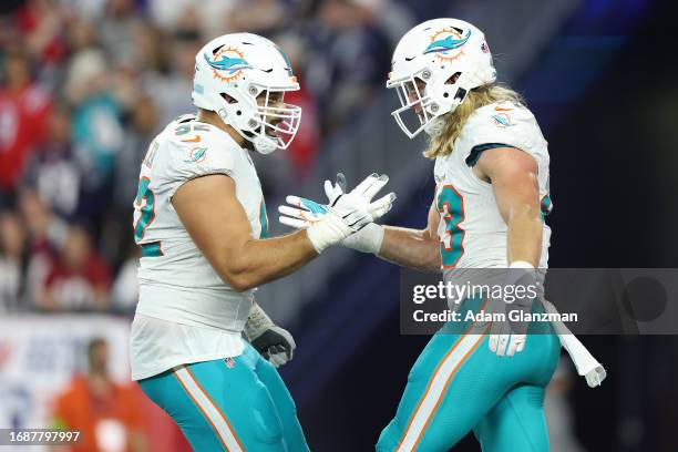 Andrew Van Ginkel of the Miami Dolphins celebrates a defensive play with Zach Sieler during the second half against the New England Patriots at...