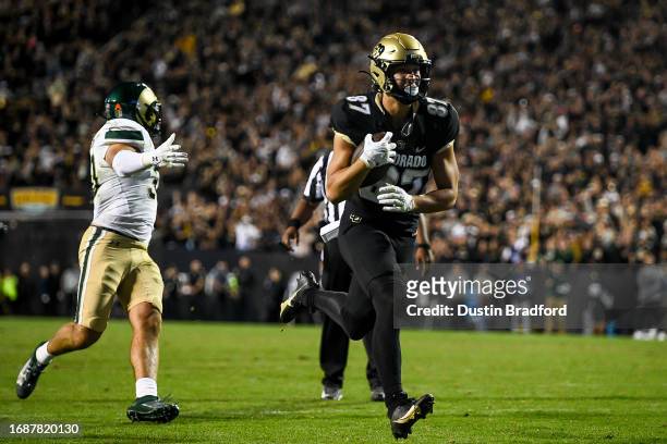 Tight end Michael Harrison of the Colorado Buffaloes runs the ball after a catch for a touchdown in the second overtime period against the Colorado...