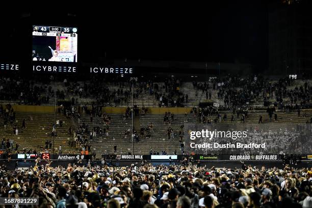 Fans storm the field after a Colorado Buffaloes win against the Colorado State Rams at Folsom Field on September 17, 2023 in Boulder, Colorado.