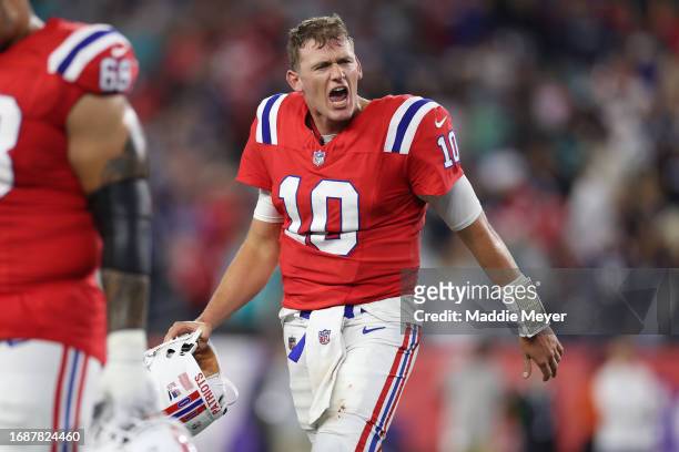 Mac Jones of the New England Patriots reacts after officials overturned a spot to turn the ball over and end the game \amia at Gillette Stadium on...