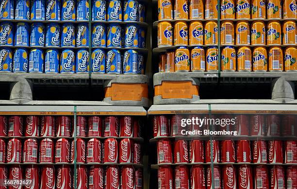 Completed aluminium cans produced for A.G Barr Plc's Rubicon drink, and Coca-Cola Co.'s Coke and Fanta drinks sit stored ahead of shipping at Rexam...