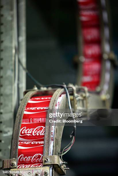 Aluminium cans produced for Coca-Cola Co.'s Coke drink move along the production line at Rexam Plc's beverage can plant in Wakefield, U.K., on...