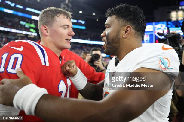 Mac Jones of the New England Patriots hugs Tua Tagovailoa of the Miami Dolphins following the game at Gillette Stadium on September 17, 2023 in...