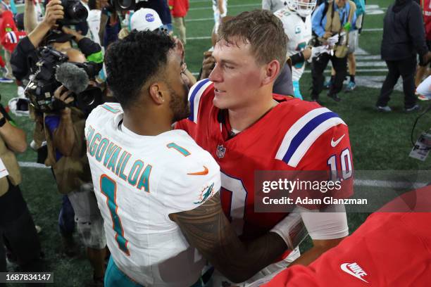 Mac Jones of the New England Patriots hugs Tua Tagovailoa of the Miami Dolphins following the game at Gillette Stadium on September 17, 2023 in...