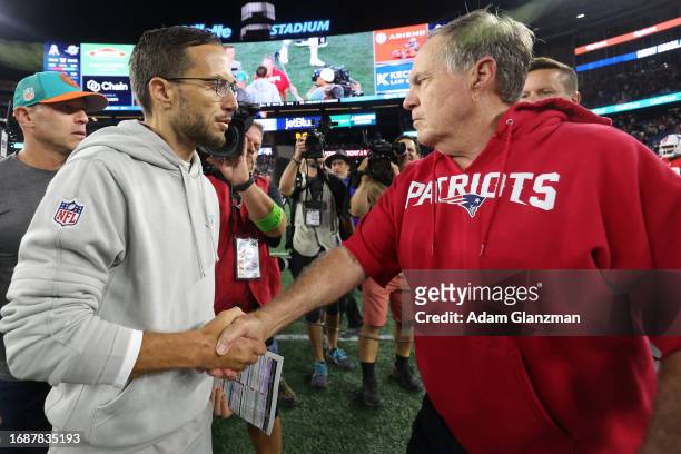 Head coach Mike McDaniel of the Miami Dolphins shakes hands with Head coach Bill Belichick of the New England Patriots following the game at Gillette...
