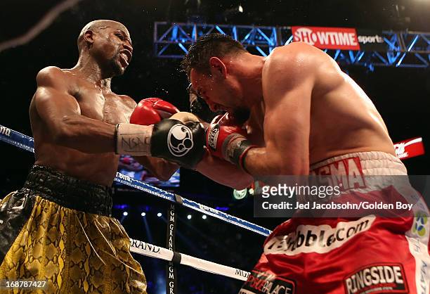 Floyd Mayweather Jr. Throws a right to the body of Robert Guerrero in their WBC welterweight title bout at the MGM Grand Garden Arena on May 4, 2013...