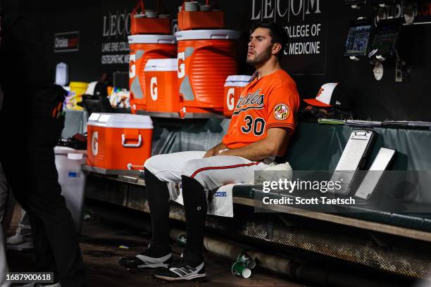 Grayson Rodriguez of the Baltimore Orioles looks on from the dugout during the ninth inning against the Tampa Bay Rays at Oriole Park at Camden Yards...