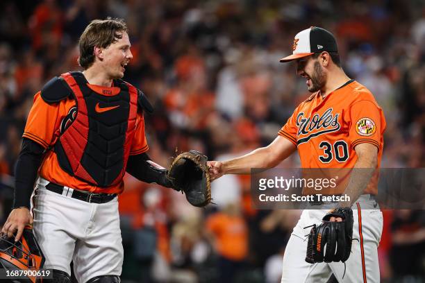 Adley Rutschman and Grayson Rodriguez of the Baltimore Orioles celebrate after the seventh inning against the Tampa Bay Rays at Oriole Park at Camden...