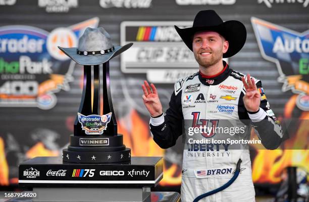 William Byron of the Liberty University Chevrolet poses with the trophy after winning the NASCAR Cup Series Playoff Autotrader EchoPark Automotive...