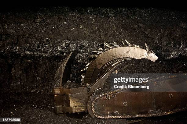 Carbide-tipped shearer scrapes coal from the wall during longwall coal mining operations at the Consol Energy Bailey Mine in Wind Ridge,...