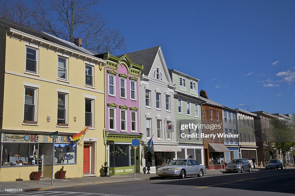 Yellow, pink, grey and green building facades