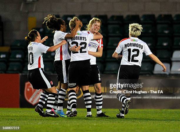 Emily Roberts of Lincoln Ladies celebrates with her team-mates after scoring the first goal of the game for her side during the FA WSL match between...