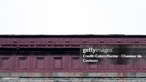 Retro-style painted metal cornice from the flat roof of a house and cloudy skies in Montreal, Quebec, Canada Retro-style painted metal cornice from the flat roof of a house and cloudy skies in Montreal, Quebec, Canada