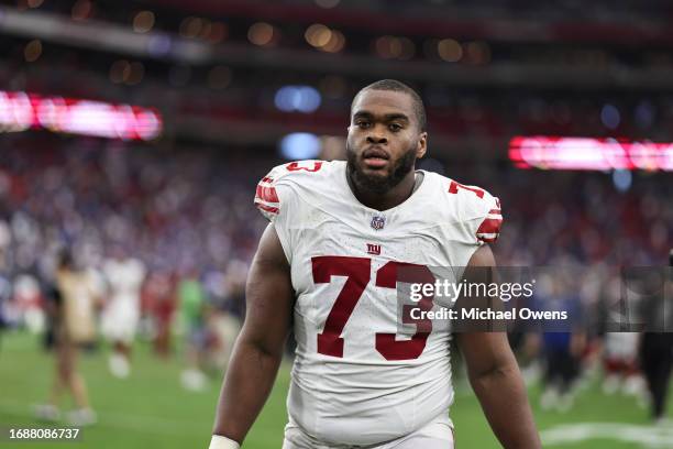 Evan Neal of the New York Giants looks on following an NFL football game between the Arizona Cardinals and the New York Giants at State Farm Stadium...