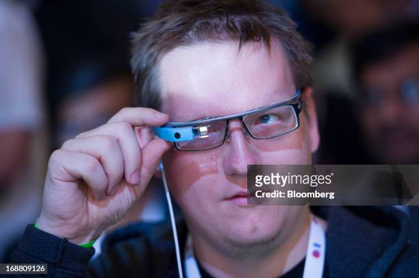 An attendee adjusts his Google Project Glass glasses during the Google I/O Annual Developers Conference in San Francisco, California, U.S., on...