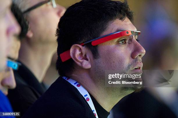 An attendee wears Google Project Glass while listening to a keynote speech during the Google I/O Annual Developers Conference in San Francisco,...