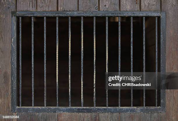 close up of steel bars in a wooden building - security screen stockfoto's en -beelden