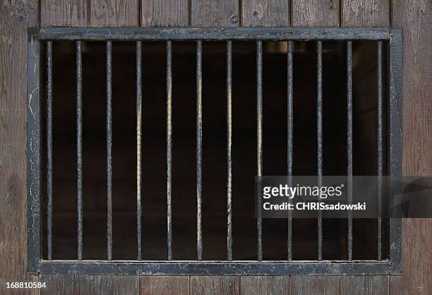 close up of steel bars in a wooden building - prison building stock pictures, royalty-free photos & images