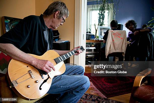 Kevin Haugh plays while Eli Schwartz , right, edits music with engineer Jason Bitner. Mountain of Leopards, an independent record label is...