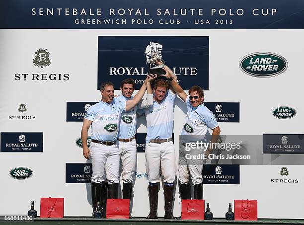 Prince Harry poses with trophy and Marc Ganzi, Malcom Borwick and Michael A. Carrazza of team Sentebale Land Rover at the Greenwich Polo Club during...